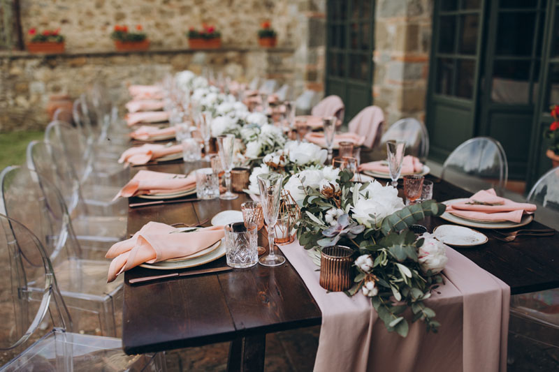 A pastel dinner placement awaits guests attending a dinner party hosted and curated by an event coordinating service.